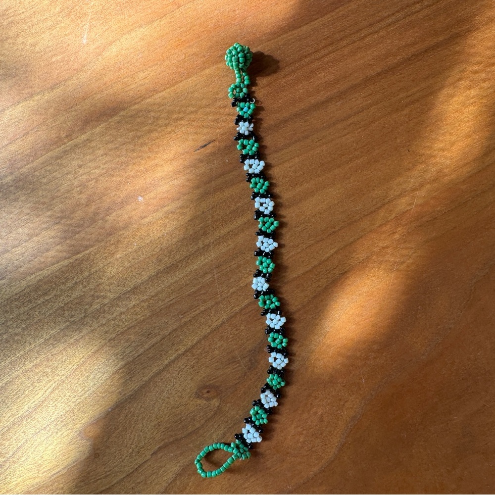 Handmade beaded bracelet. Green white and black beads.